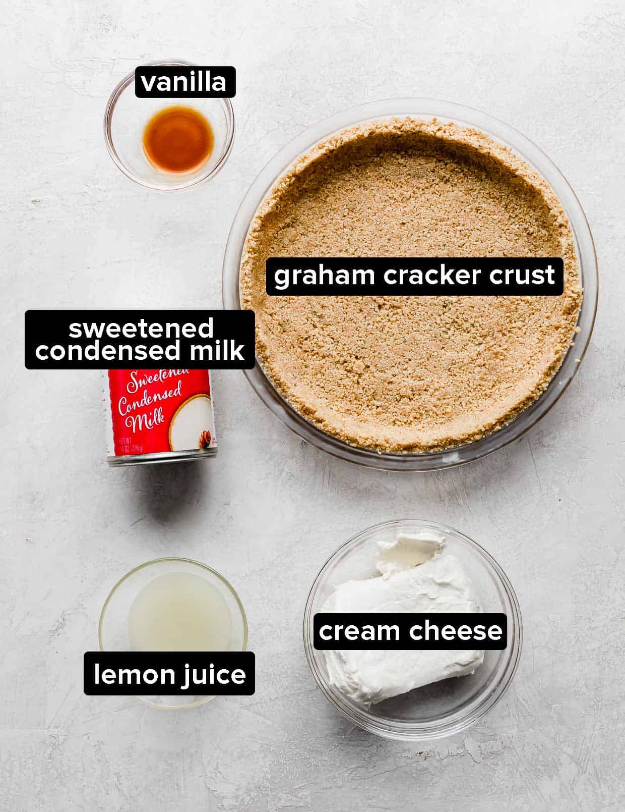 Ingredients used to make a no-bake cheesecake; cream cheese, lemon juice, vanilla, and condensed milk.