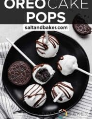 white chocolate covered Oreo Cake Pops on a black plate.