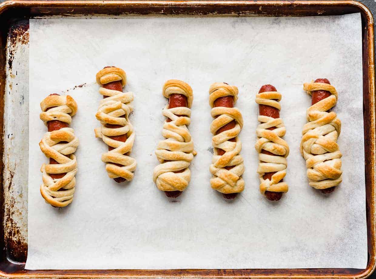 Baked Mummy Hot Dogs on a baking sheet. 