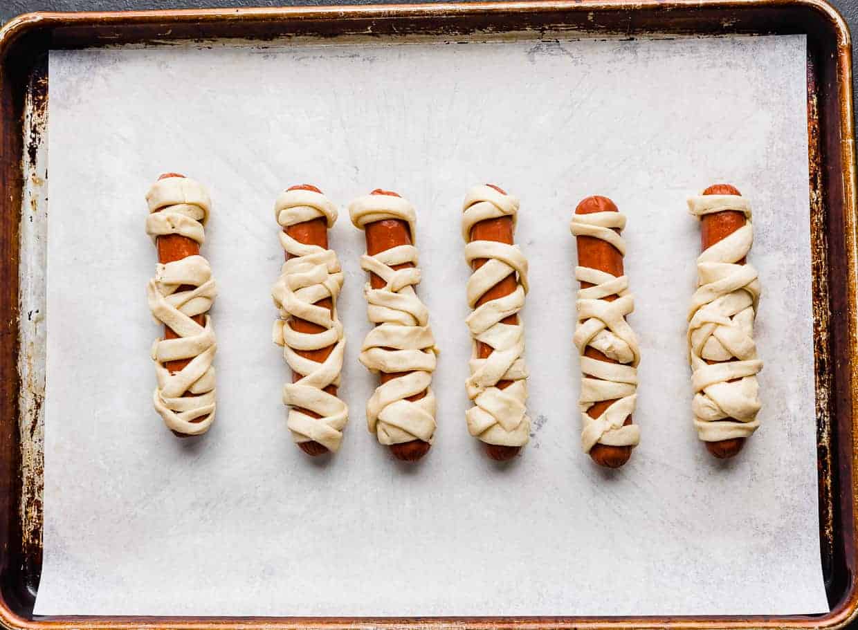 Hot dogs wrapped in crescent roll strips. 