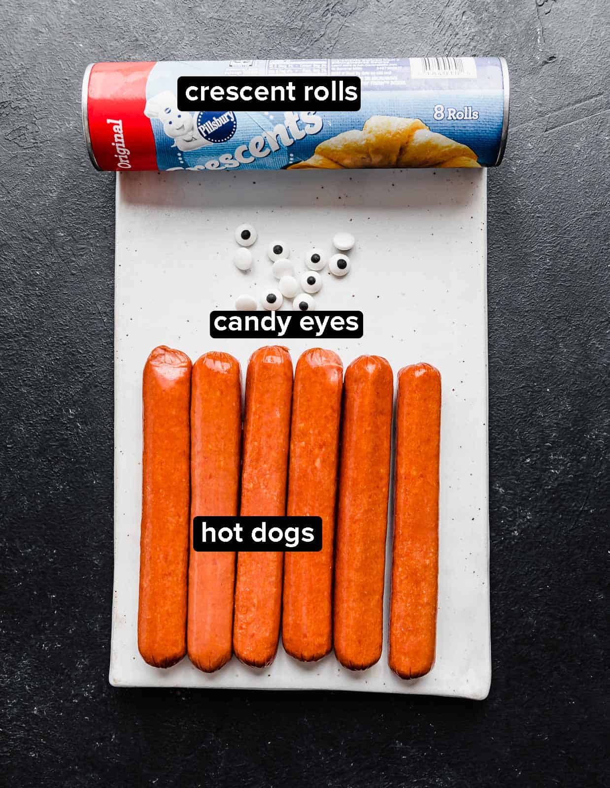 Mummy Hot Dogs ingredients on a rectangular white plate.