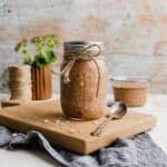 High Protein Overnight Oats in a mason jar against a wooden background.