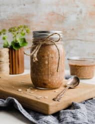 High Protein Overnight Oats in a mason jar against a wooden background.