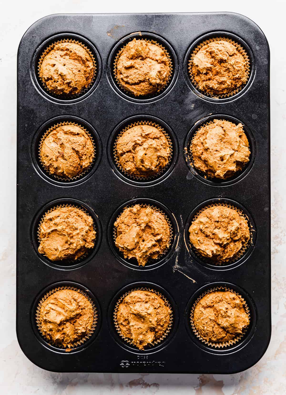 Baked 2 Ingredient Pumpkin Muffins in a 12 cavity muffin tin.