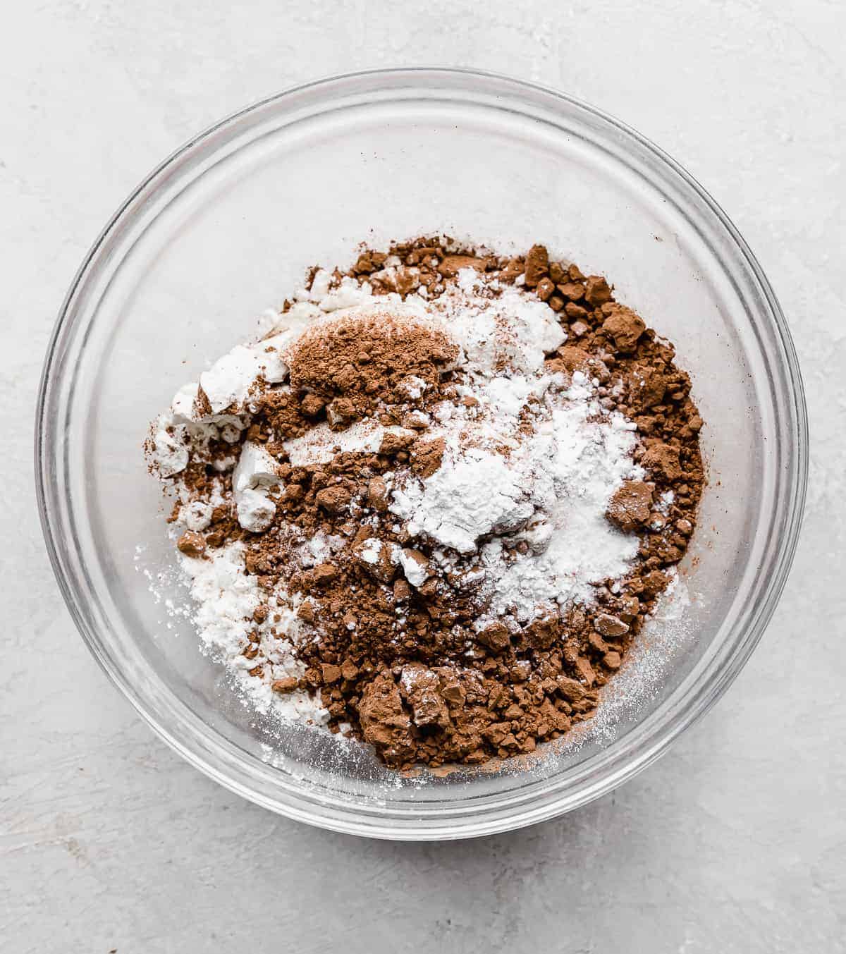 The dry ingredients for making Chocolate Doughnuts in a glass bowl.