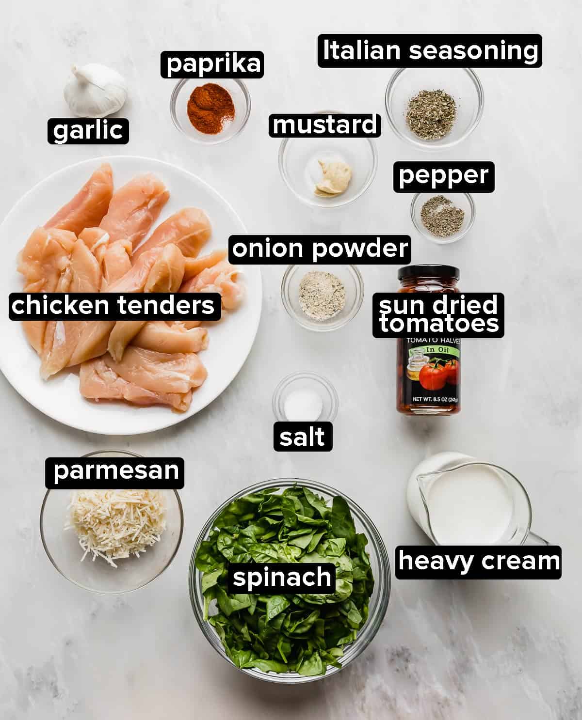 Creamy Tuscan Chicken ingredients on a gray background.