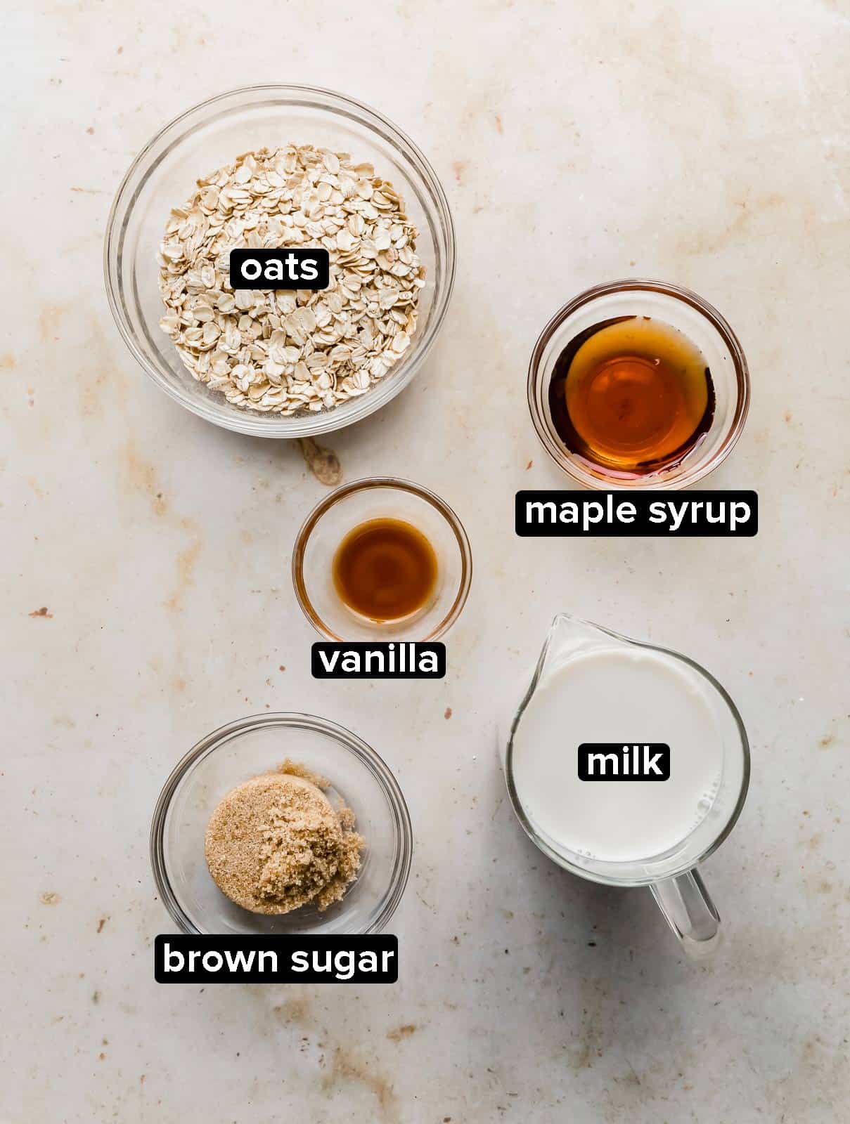 Maple and Brown Sugar Oatmeal ingredients on a cream colored background.
