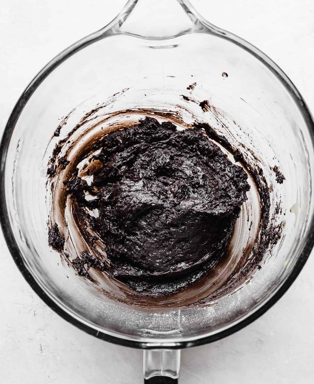 Oreo Donut batter in a glass mixing bowl.