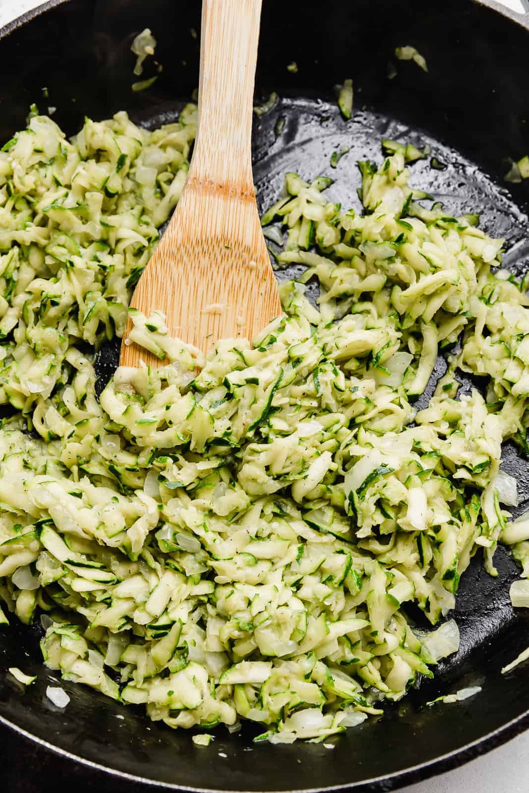 Cooked down shredded zucchini to make a zucchini sauce for pasta.