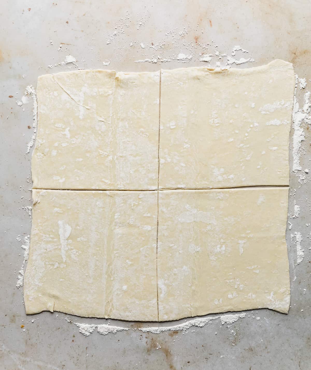 A square of puff pastry cut into 4 equal squares.