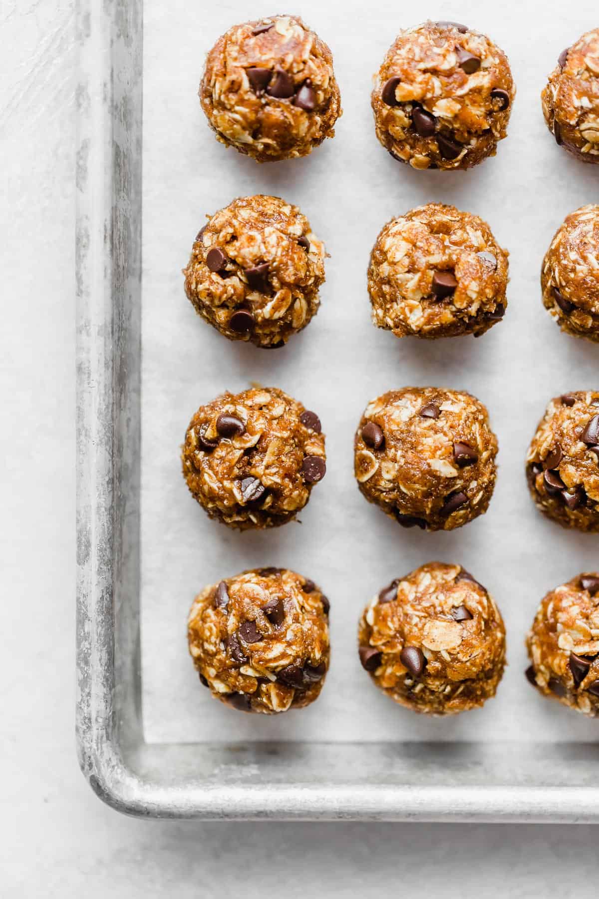 Pumpkin Energy Balls on a parchment lined baking sheet.