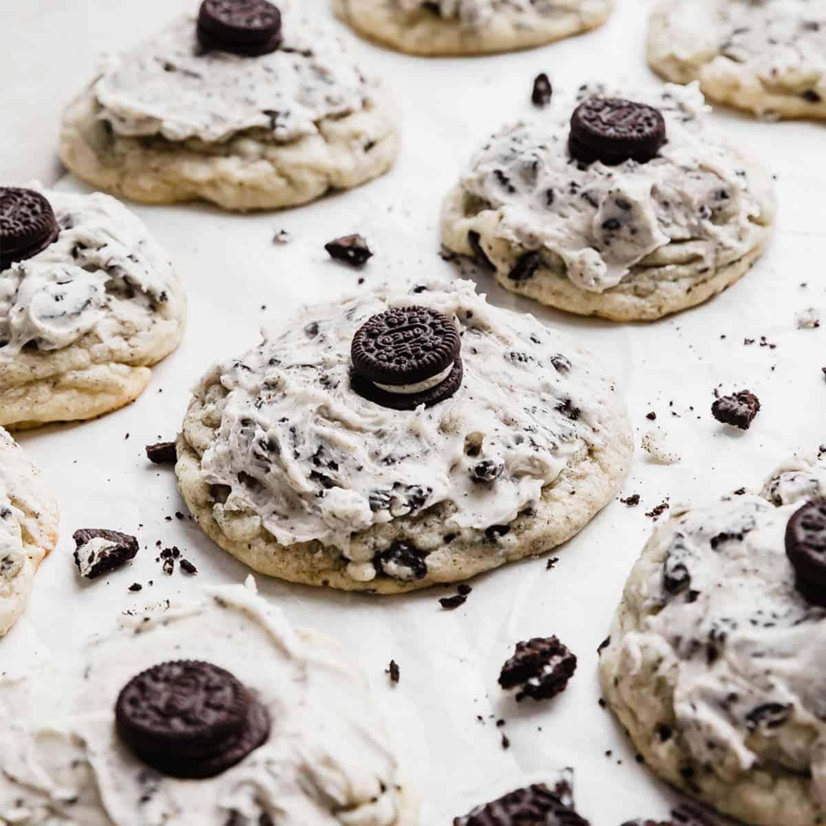 A Crumbl Cookies and Cream Milkshake Cookie on a white parchment paper.