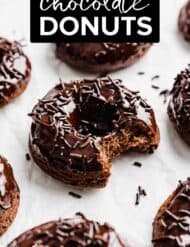 Chocolate Doughnuts topped with chocolate sprinkles, on a white background.