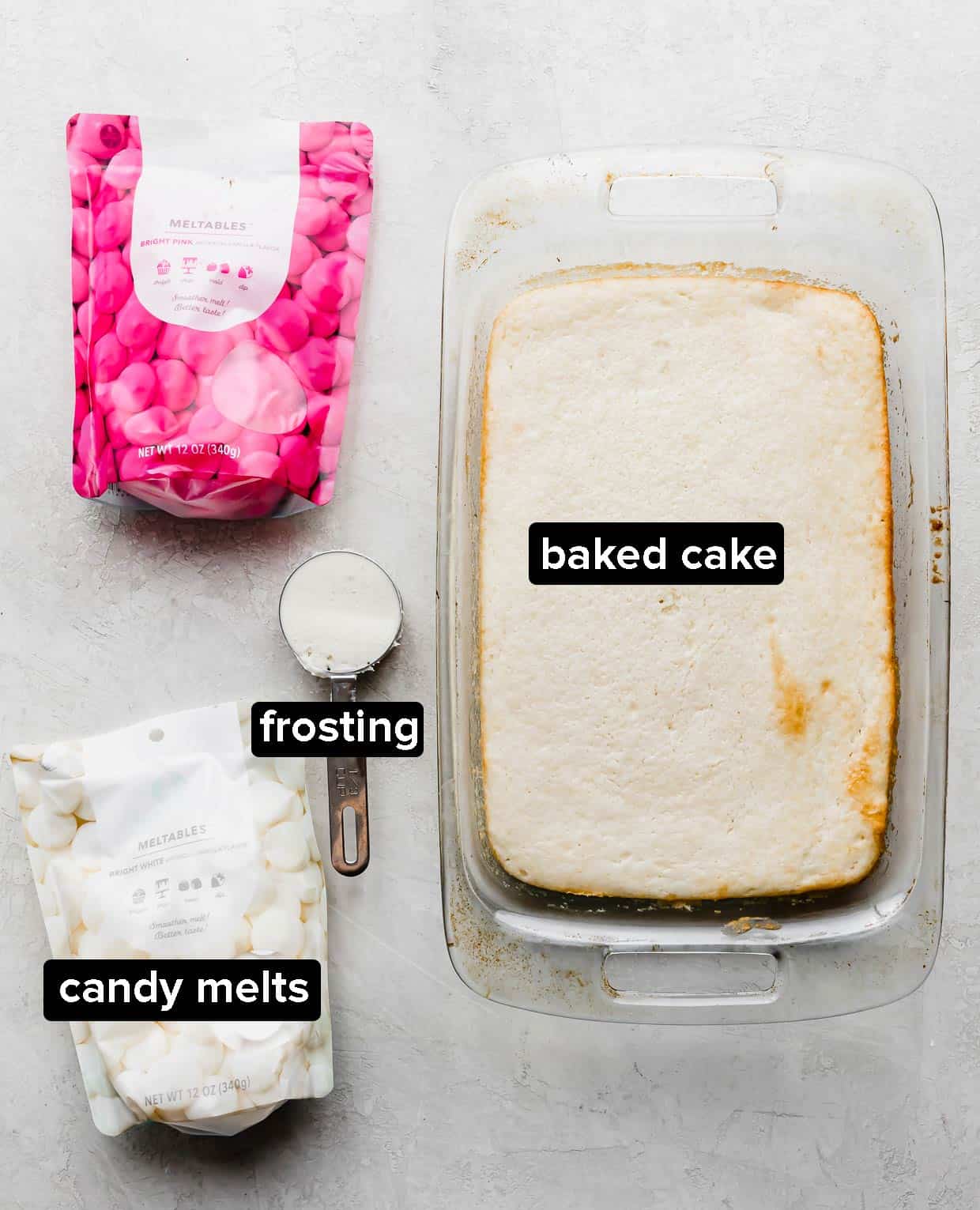 Ingredients used to make cakesicles on a gray background. 