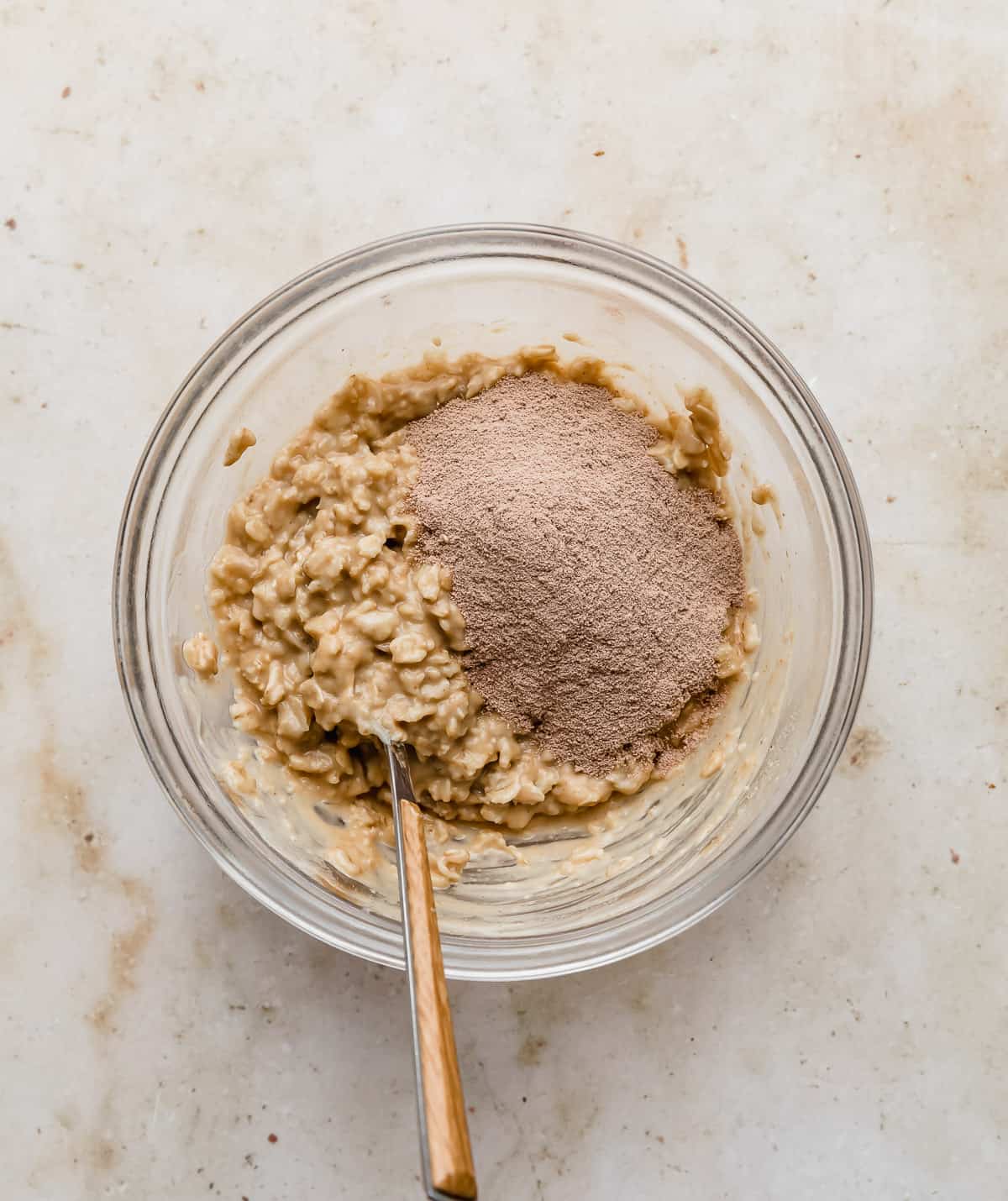 Peanut butter oatmeal with chocolate protein powder on top of it.
