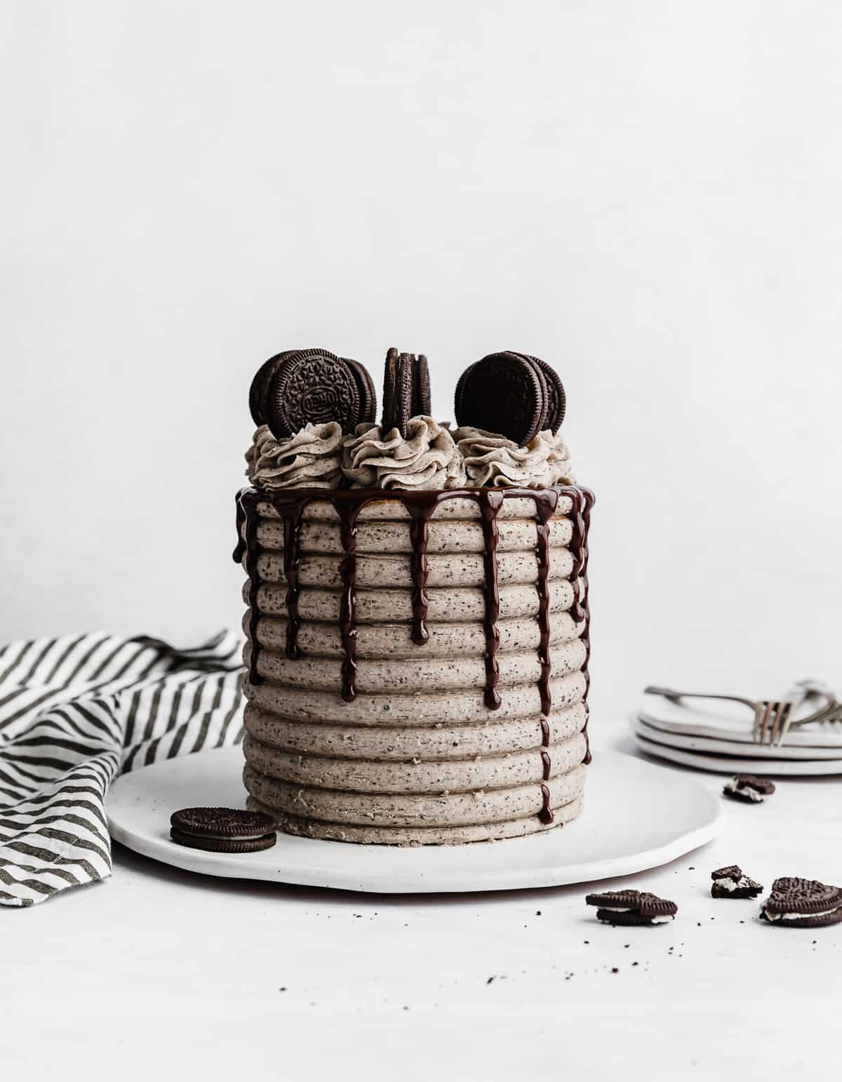 A Coconut Cookies and Cream Cake with a chocolate drip and Oreos on the top.