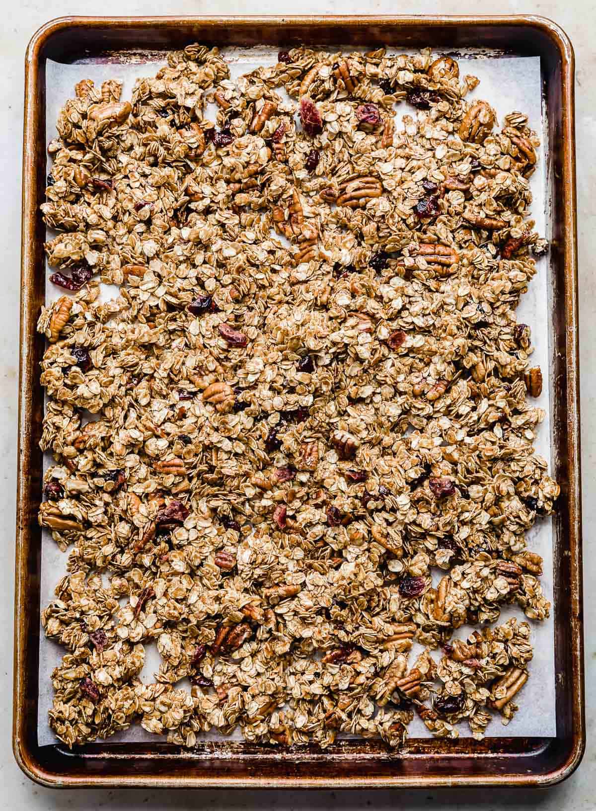 A baking sheet with Gingerbread Granola spread out on it.
