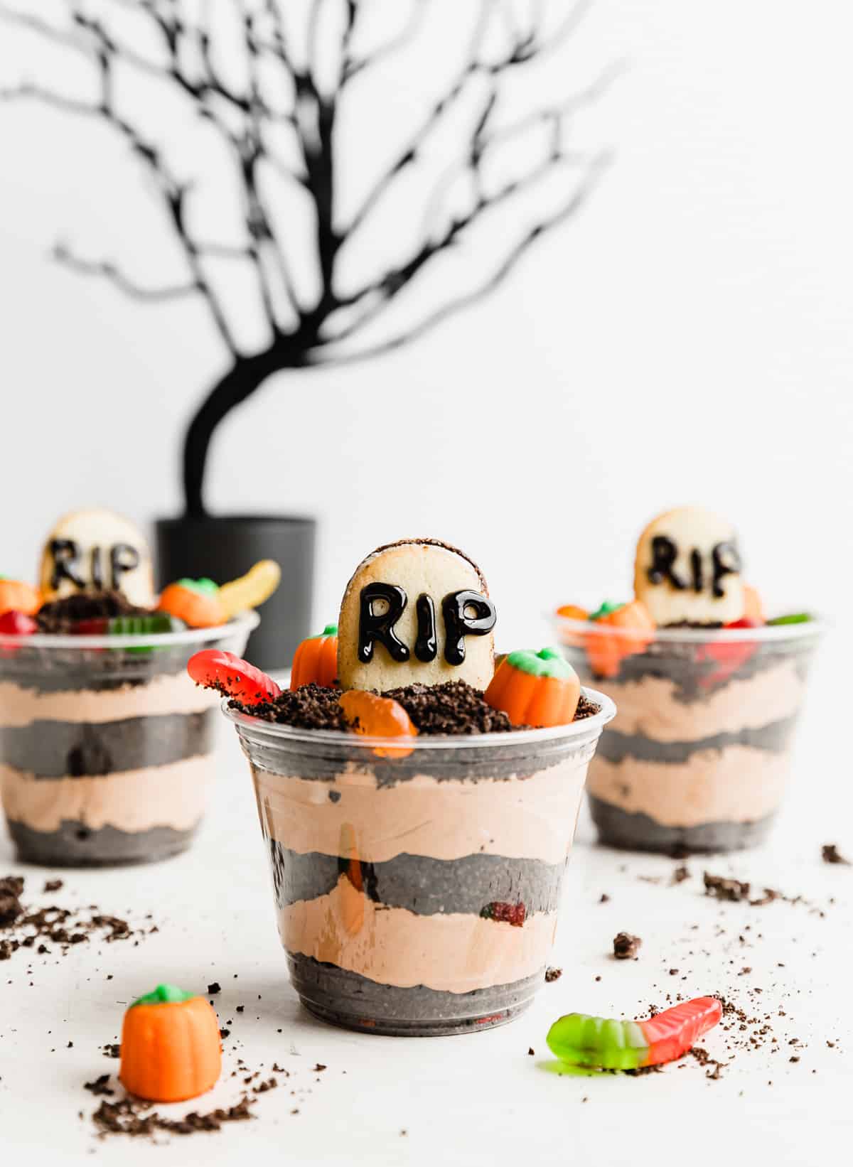 Halloween Dirt Cups on a white background with a black halloween tree in the background.
