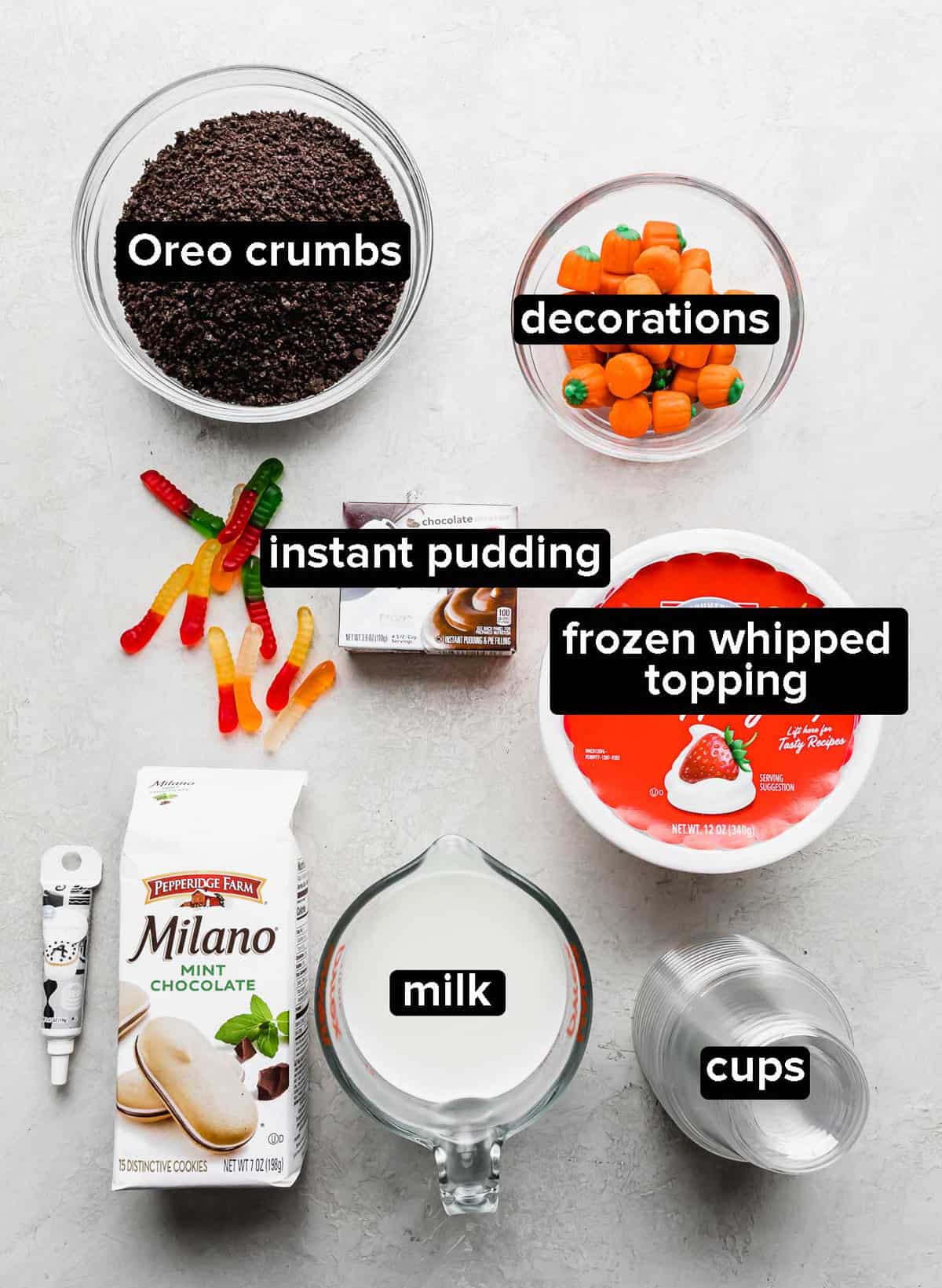 Halloween Dirt Cups ingredients on a white background.