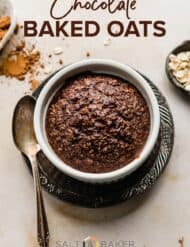 A ramekin with baked chocolate oats in it with a spoon to the left.