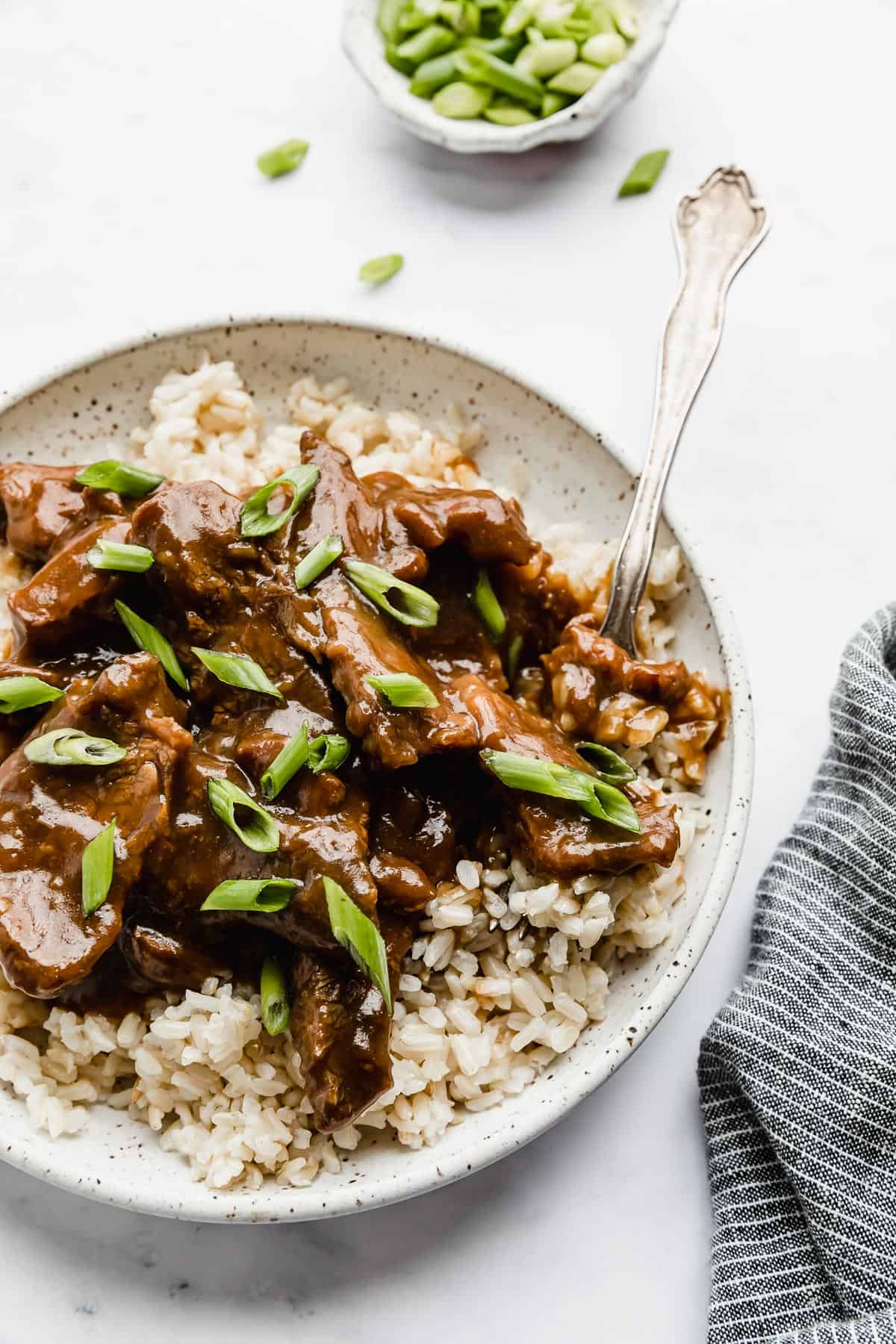 Slow Cooker Mongolian Beef on a bed of brown rice.