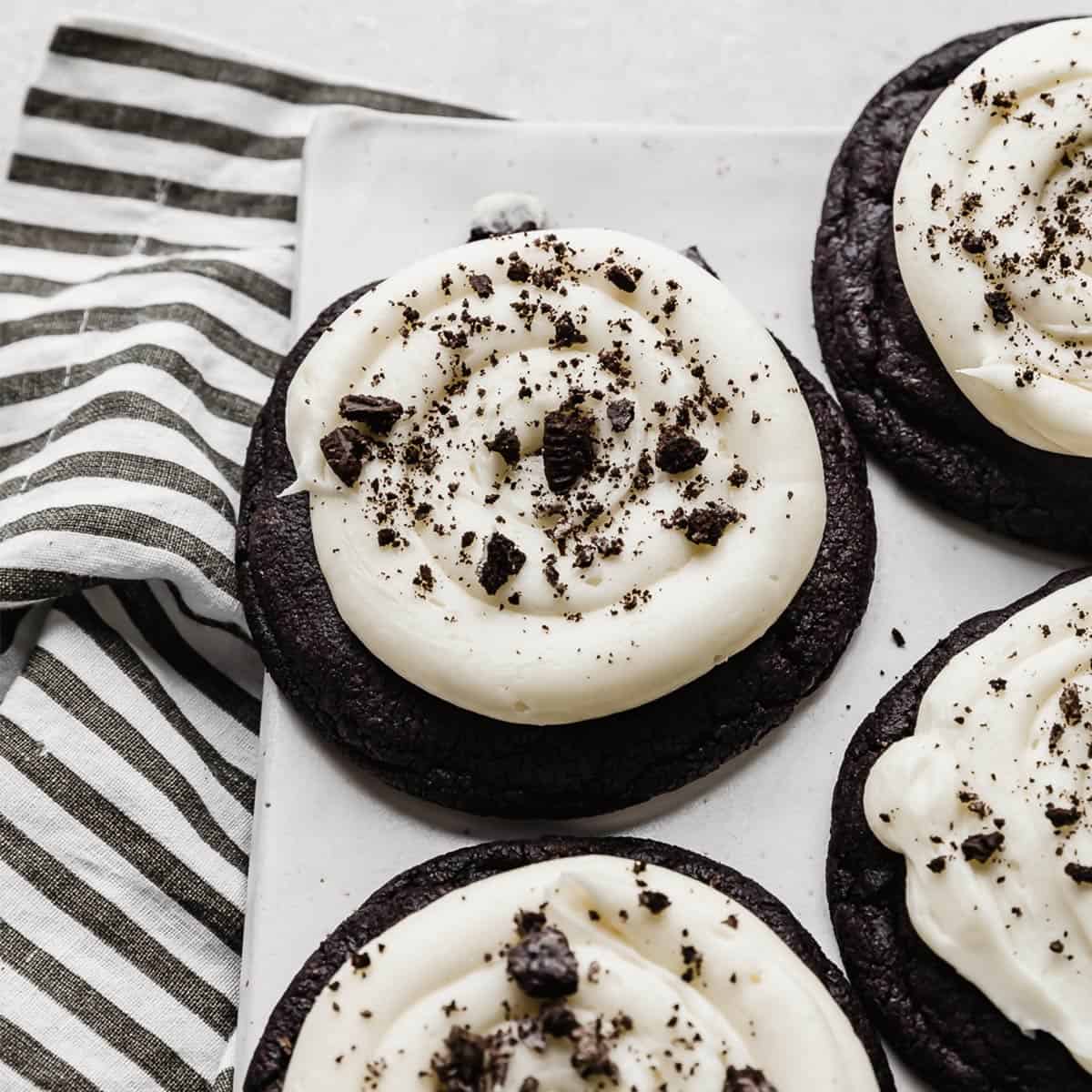 A Chocolate Oreo Crumbl Cookie on a white plate.