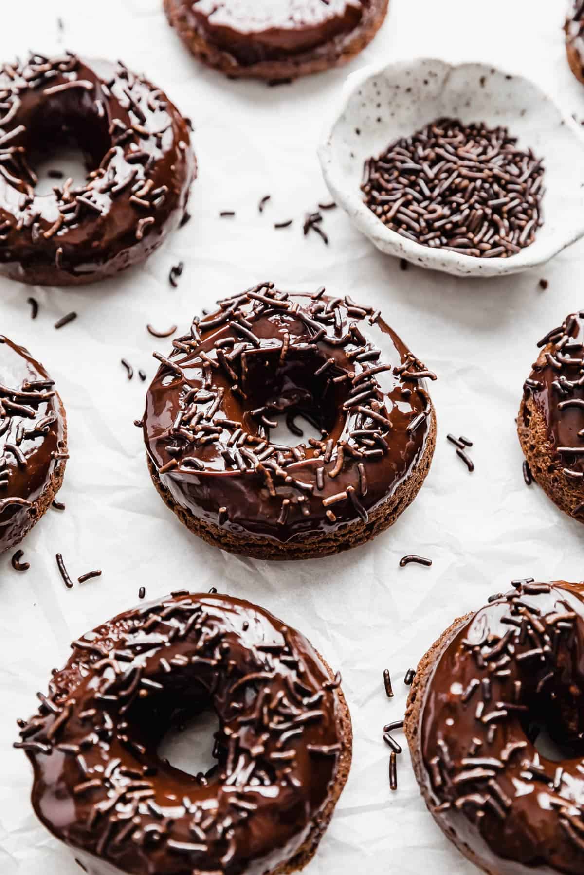 Chocolate Baked Doughnuts topped with a chocolate glaze and chocolate sprinkles.