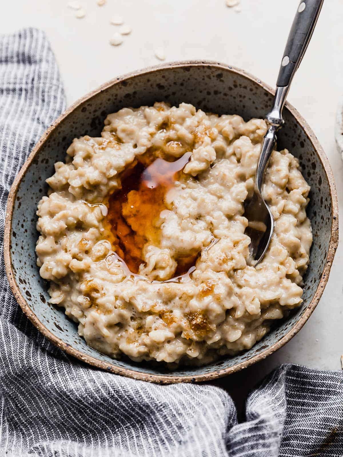 A bowl of oatmeal on a white background.