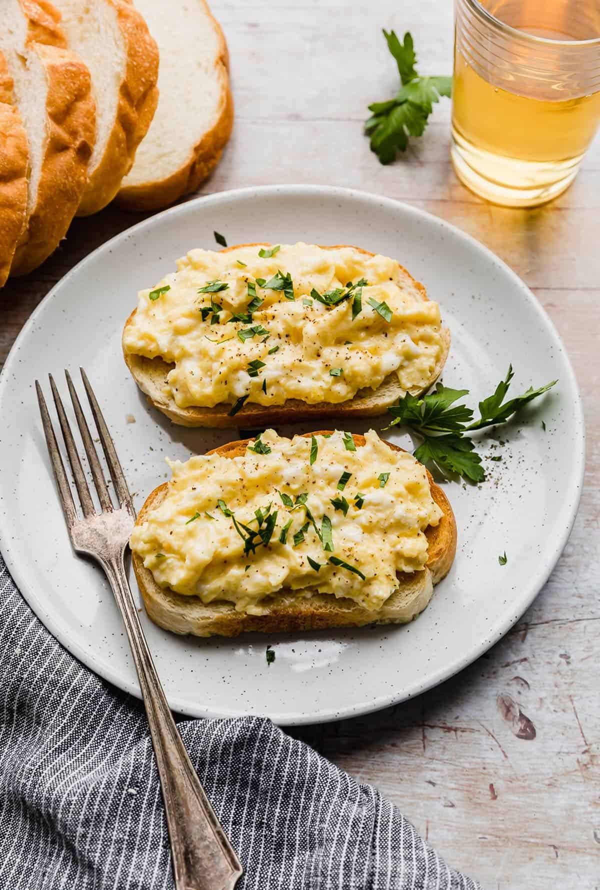 Scrambled Eggs on Toast garnished with fresh parsley.