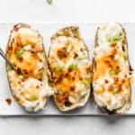 Bacon, cheese, and green onion topped Twice Baked Potatoes with Cream Cheese.