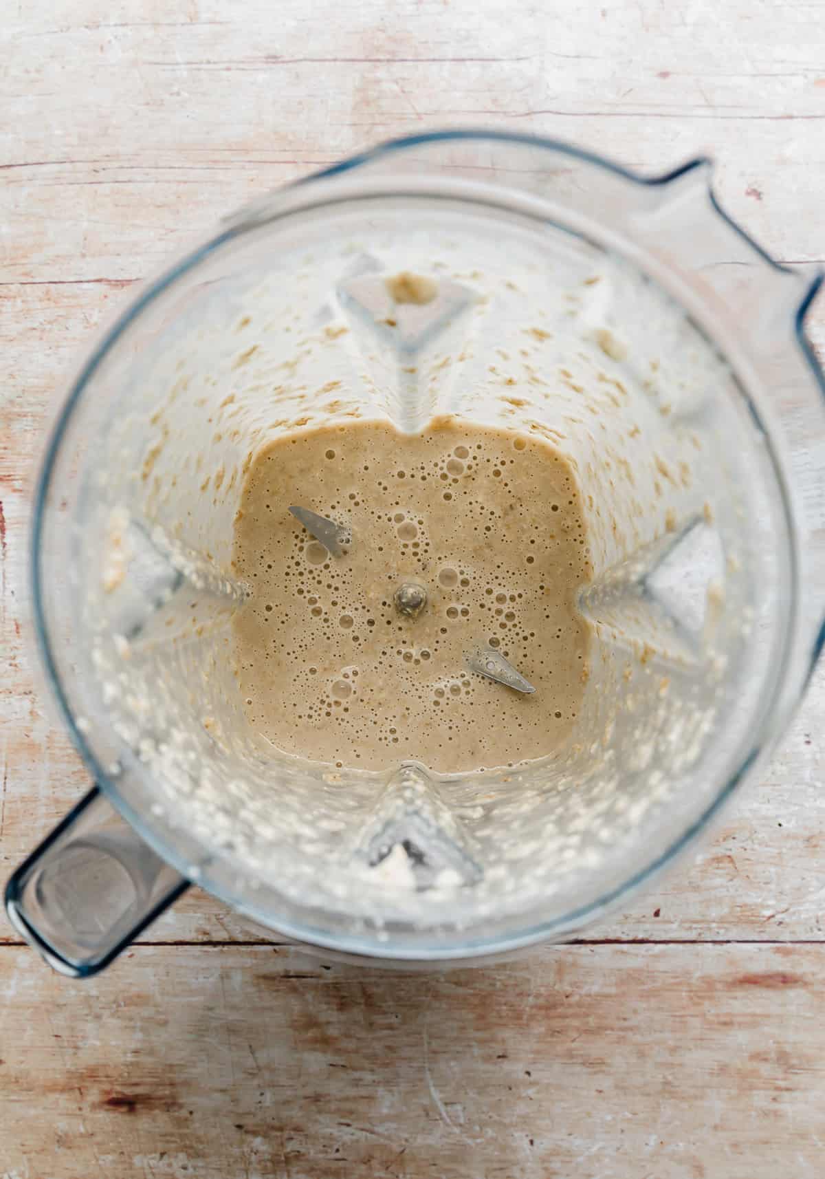 A blender with baked oats puree in it.