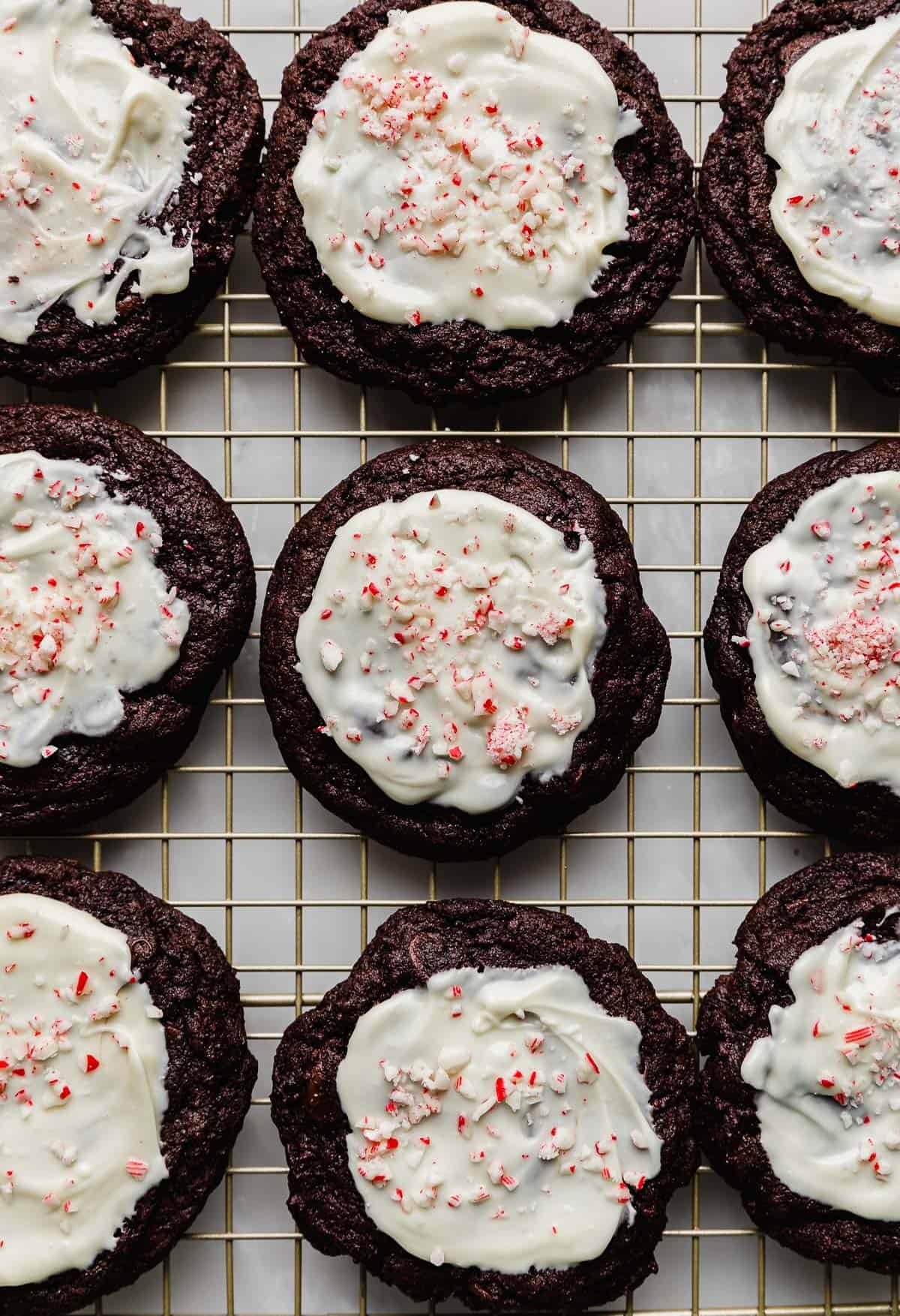 Crumbl Peppermint Bark Cookies topped with melted white chocolate and crushed candy canes.