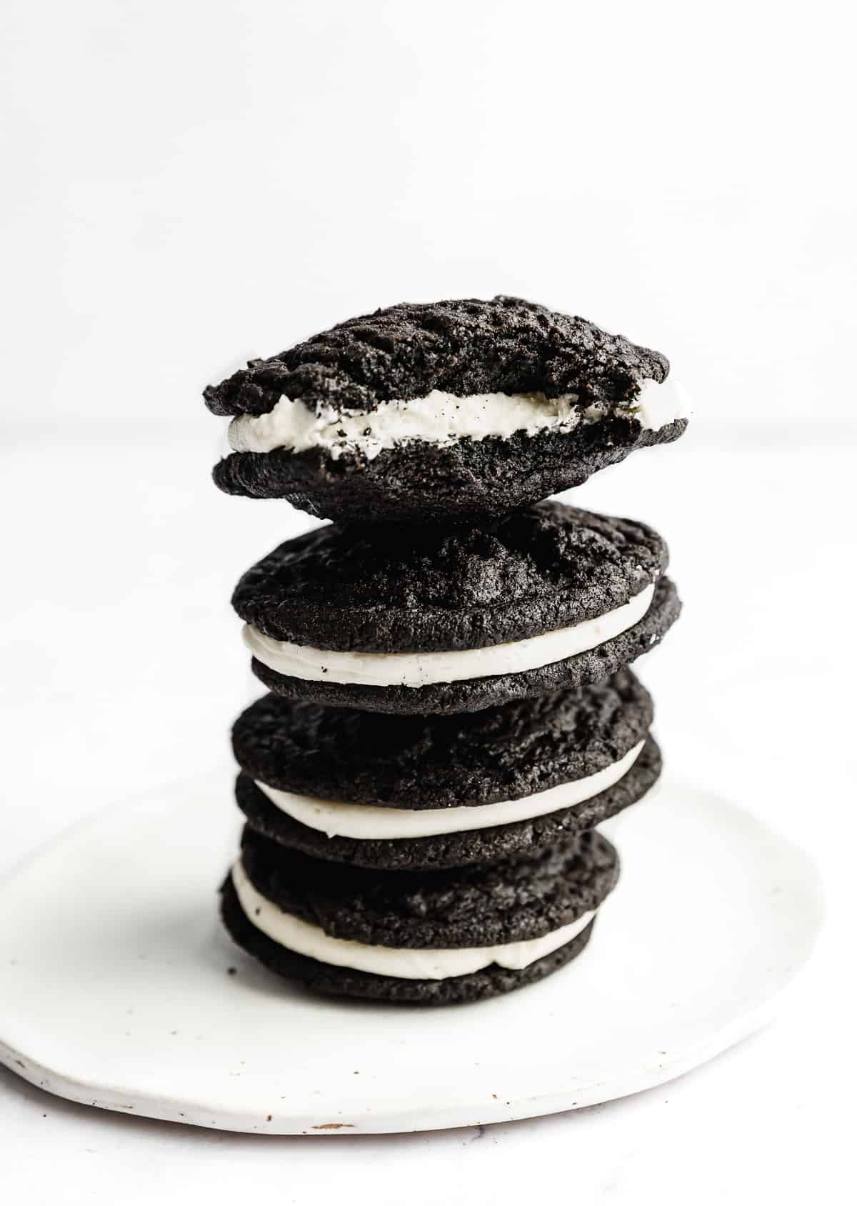Four Homemade Oreo Cookies stacked on top of each other on a white plate.