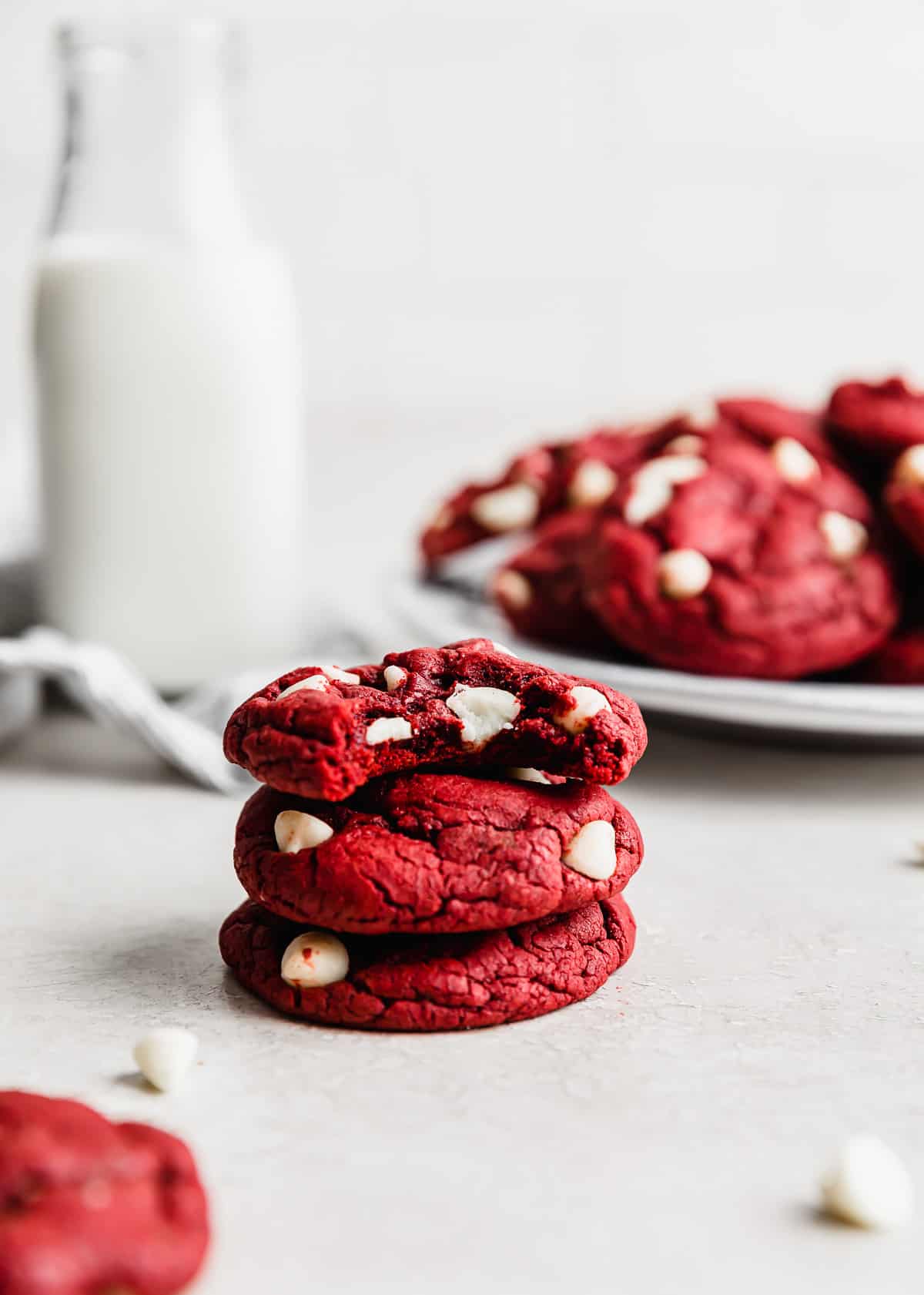 Red Velvet Cake Mix Cookies stacked on top of 2 cookies against a white background.