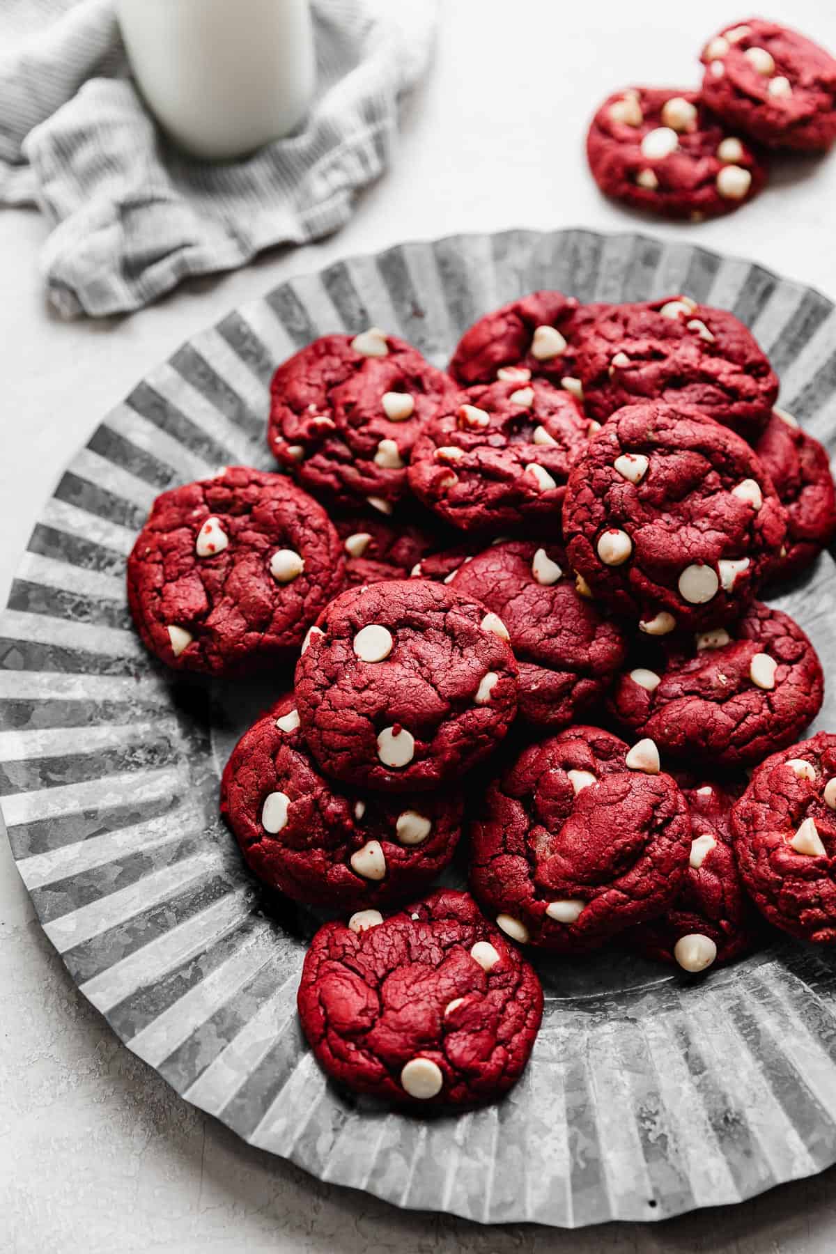 Red Velvet Cake Mix Cookies studded with white chocolate chips, on a metal fluted plate.