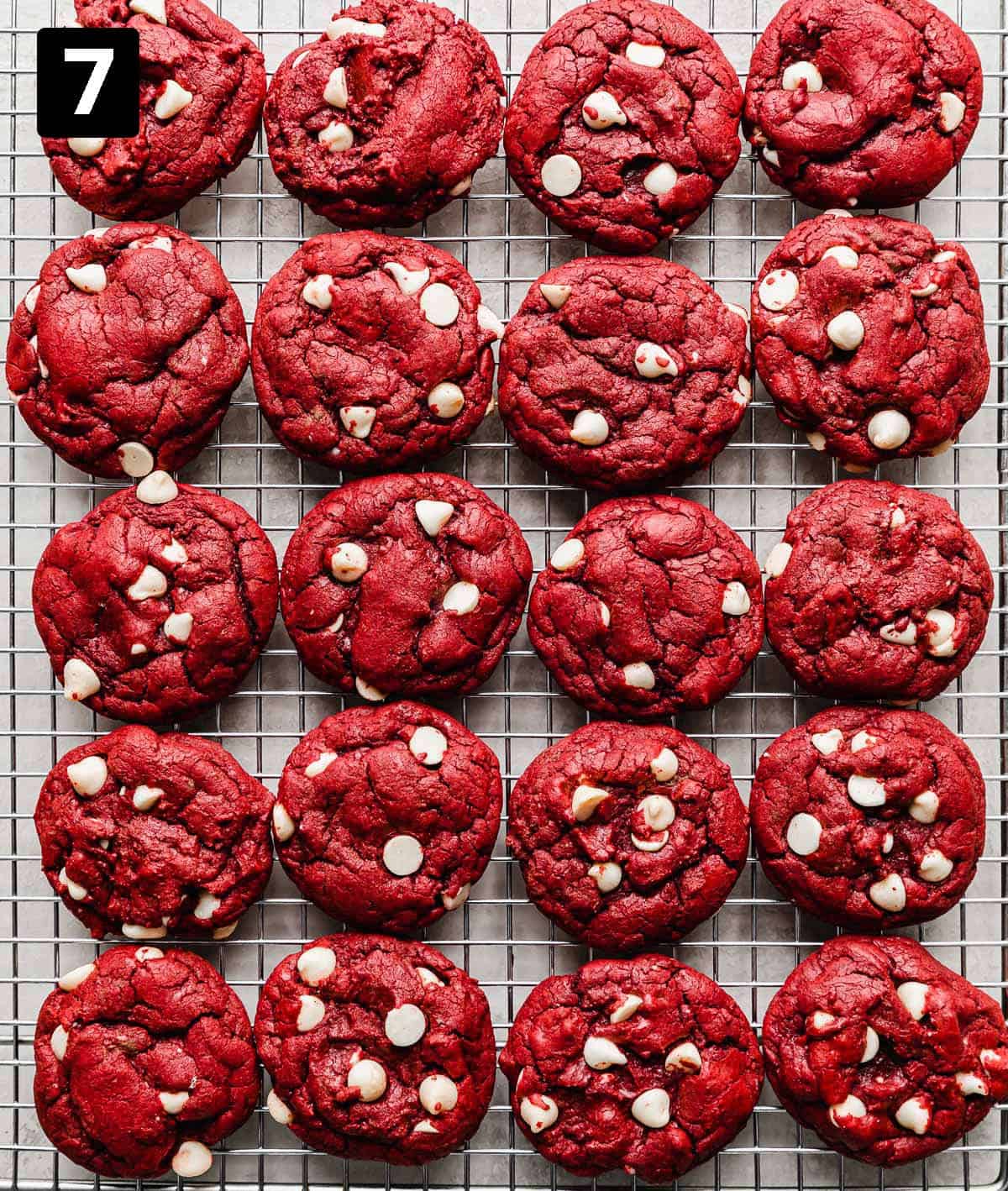 Red Velvet Cake Mix Cookies with white chocolate chips lined up on a wire cooling rack.