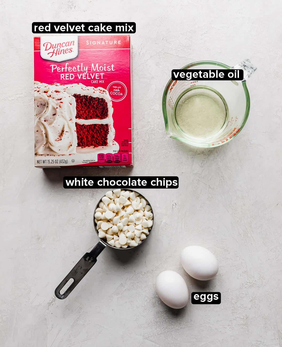 Ingredients used to make Red Velvet Cake Mix Cookies: cake mix, oil, eggs, white chocolate chips.