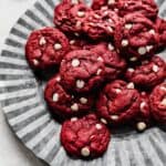 Red Velvet and white chocolate chip Cake Mix Cookies sitting on a fluted metal plate.