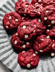 Red Velvet and white chocolate chip Cake Mix Cookies sitting on a fluted metal plate.
