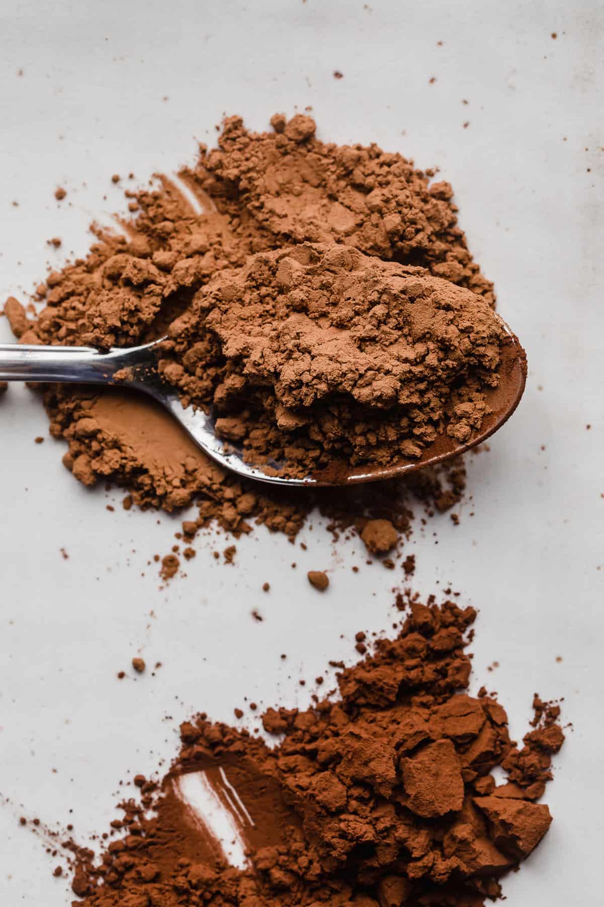 Photo of unsweetened cocoa powder on a spoon.