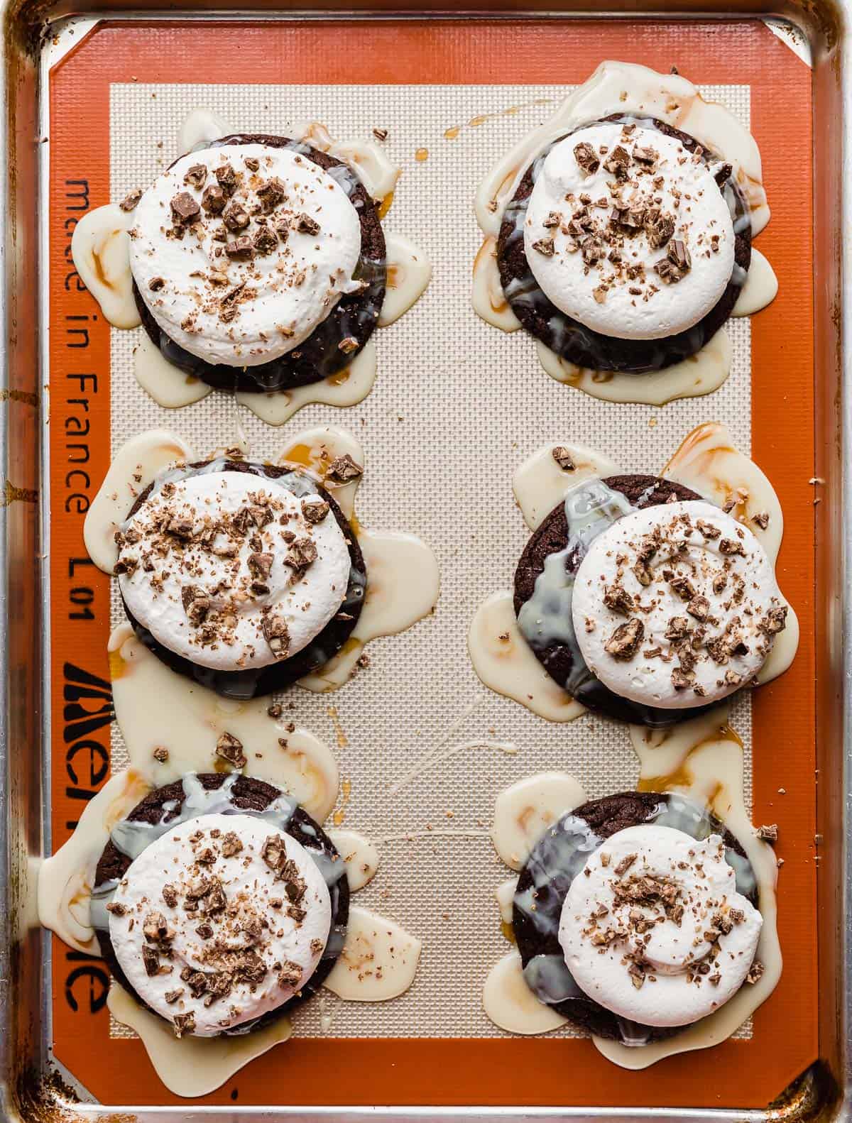 Chocolate cookies drizzled with caramel and sweetened condensed milk and topped with whipped cream and Heath.