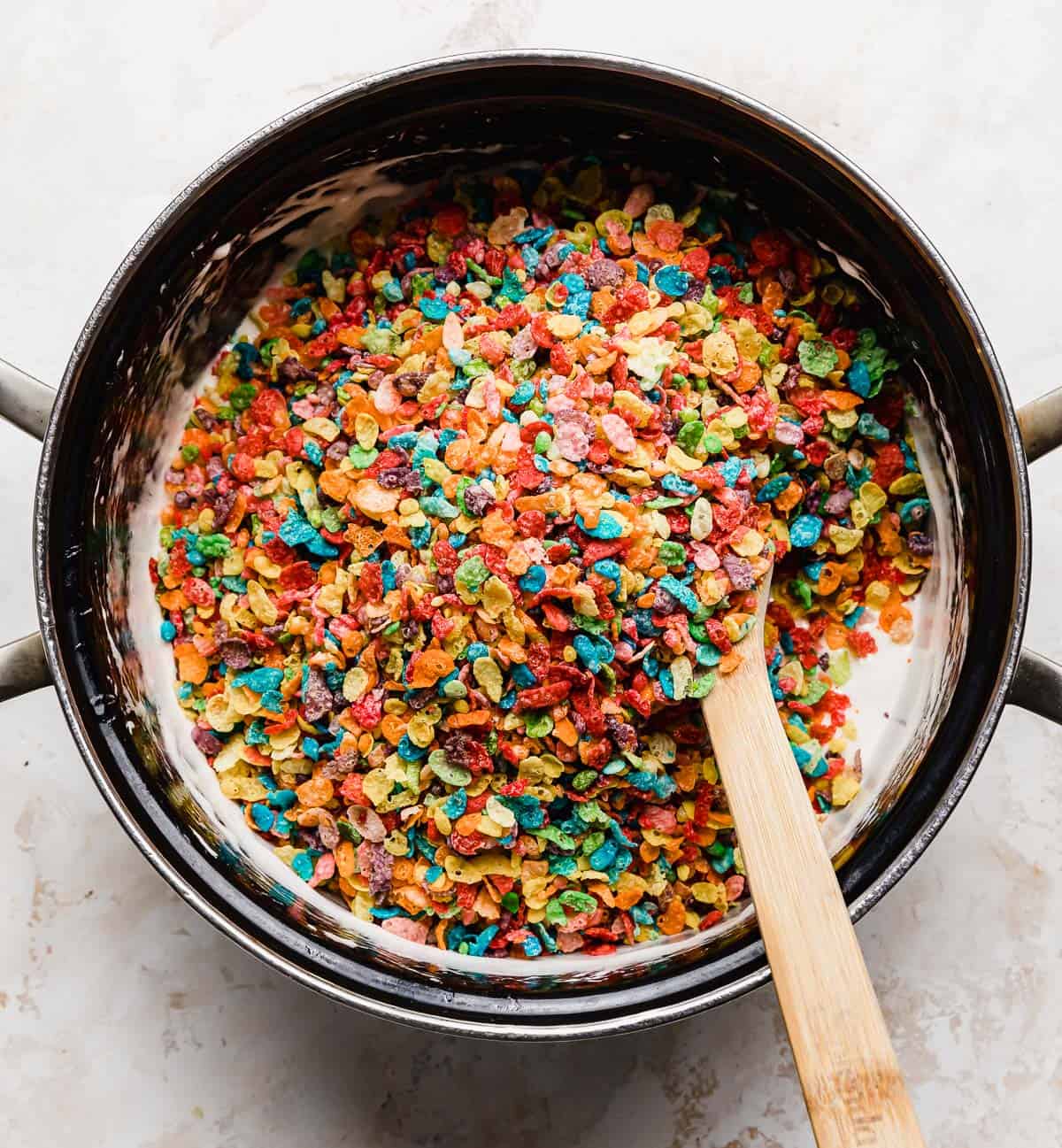Fruit pebbles cereal in a pot for making Fruity Pebble Rice Krispie Treats.