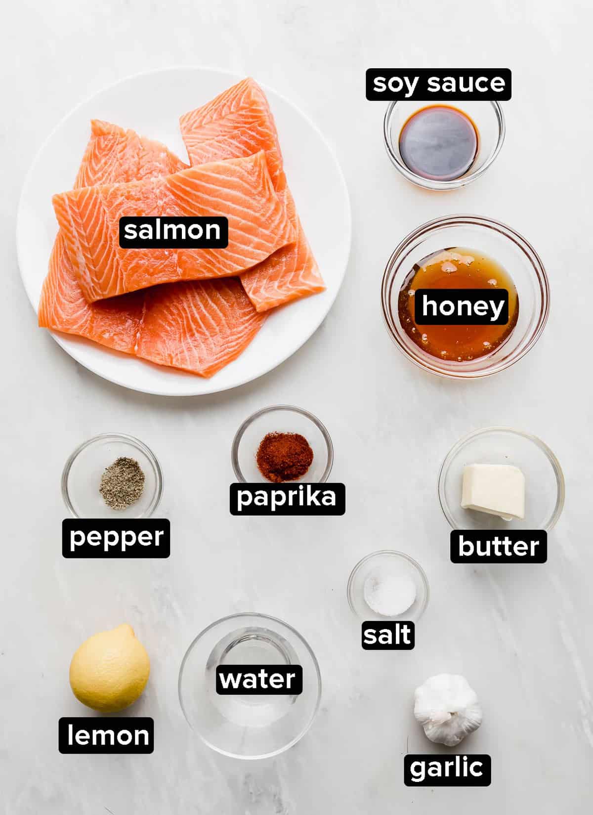 Honey Garlic Baked Salmon ingredients in small glass bowls on a light gray background.