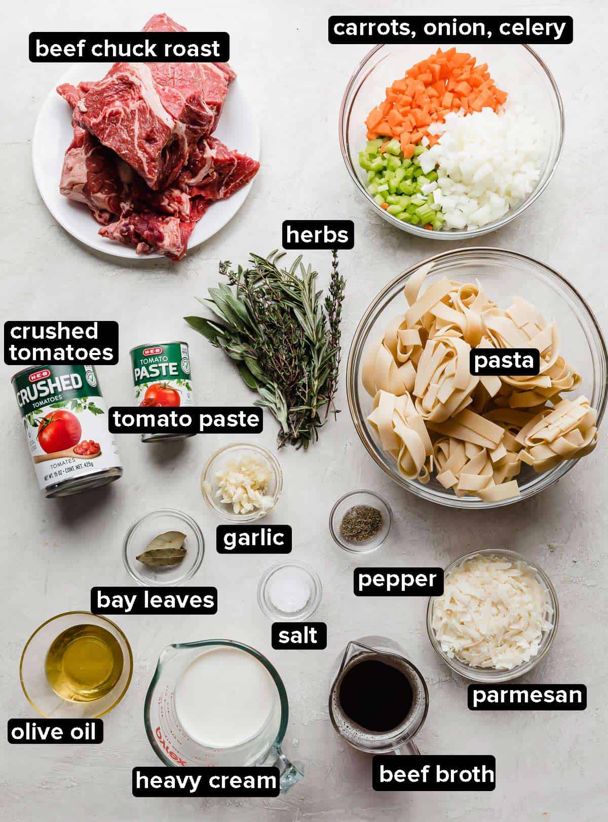 Ingredients used to make the best beef Ragu recipe, with each ingredient portioned into glass bowls on a white background.
