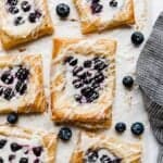 A blueberry danish recipe with fresh blueberries on top of a cream cheese filling and topped with a glaze.
