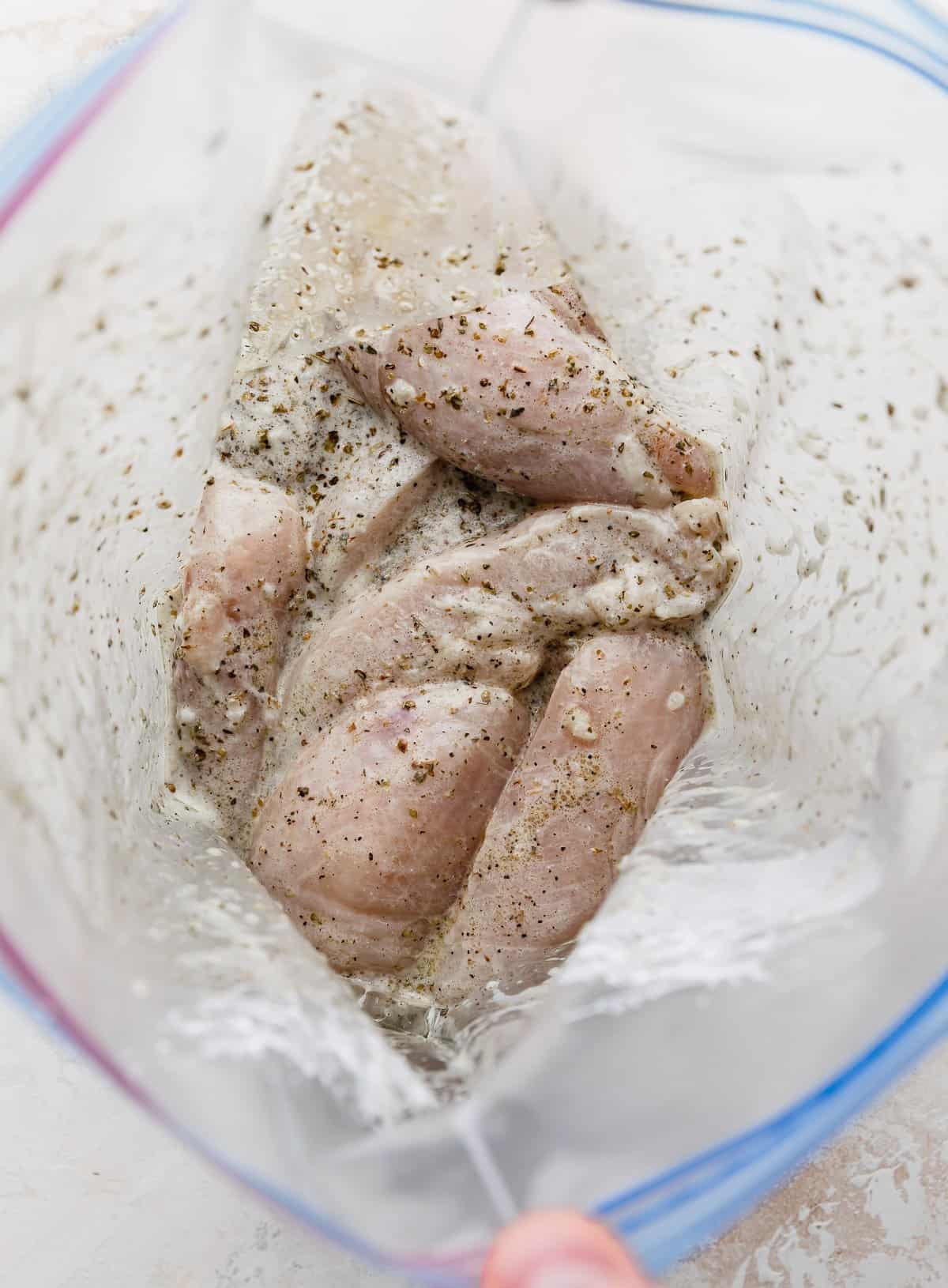 Chicken gyro marinade in a ziplock bag with chicken tenders.