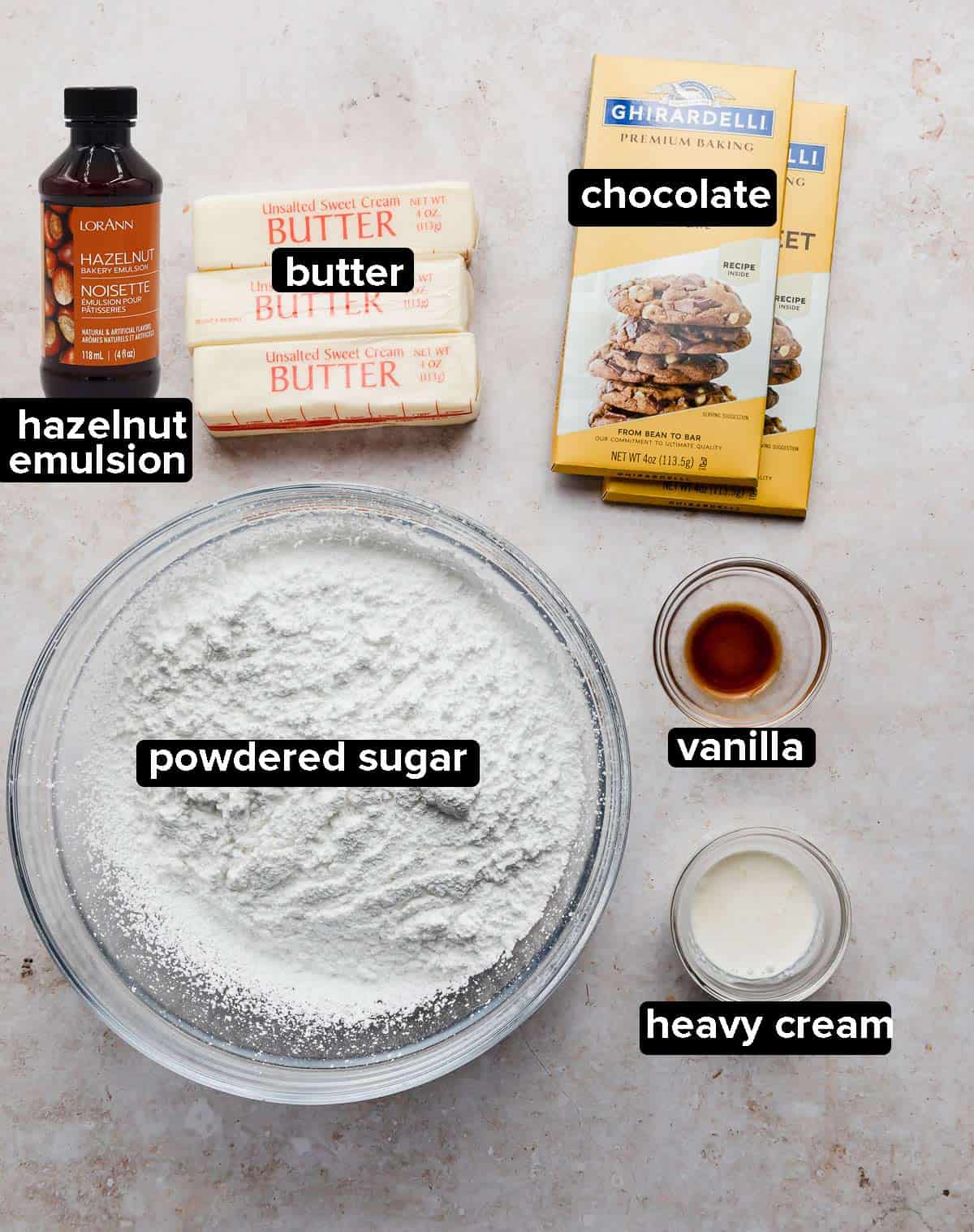 Ingredients used to make Ferrero Rocher Cupcakes on a light cream colored background. 
