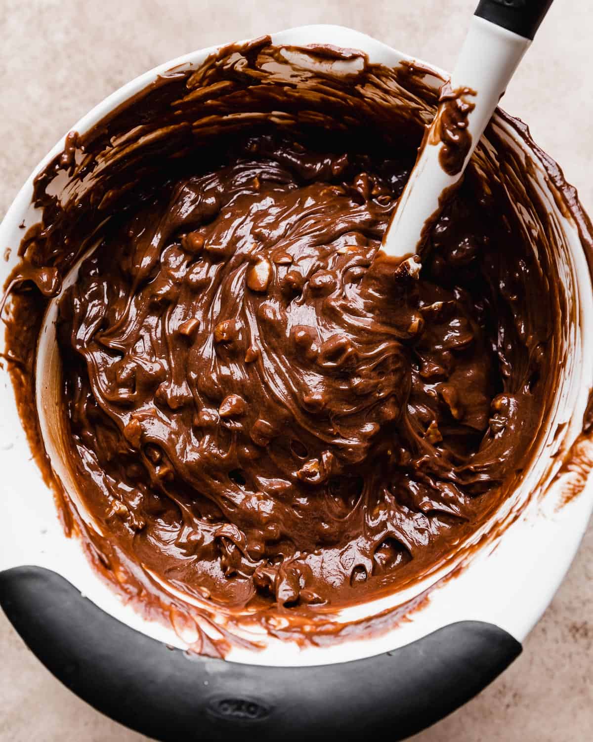 A thick creamy Nutella mixture with chopped nuts mixed in.