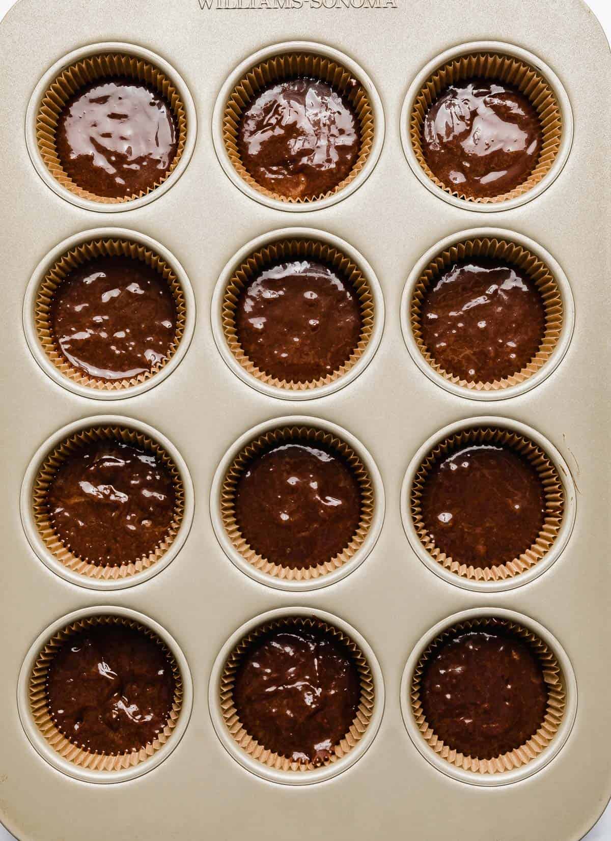 Chocolate hazelnut batter in cupcake lined muffin tin.