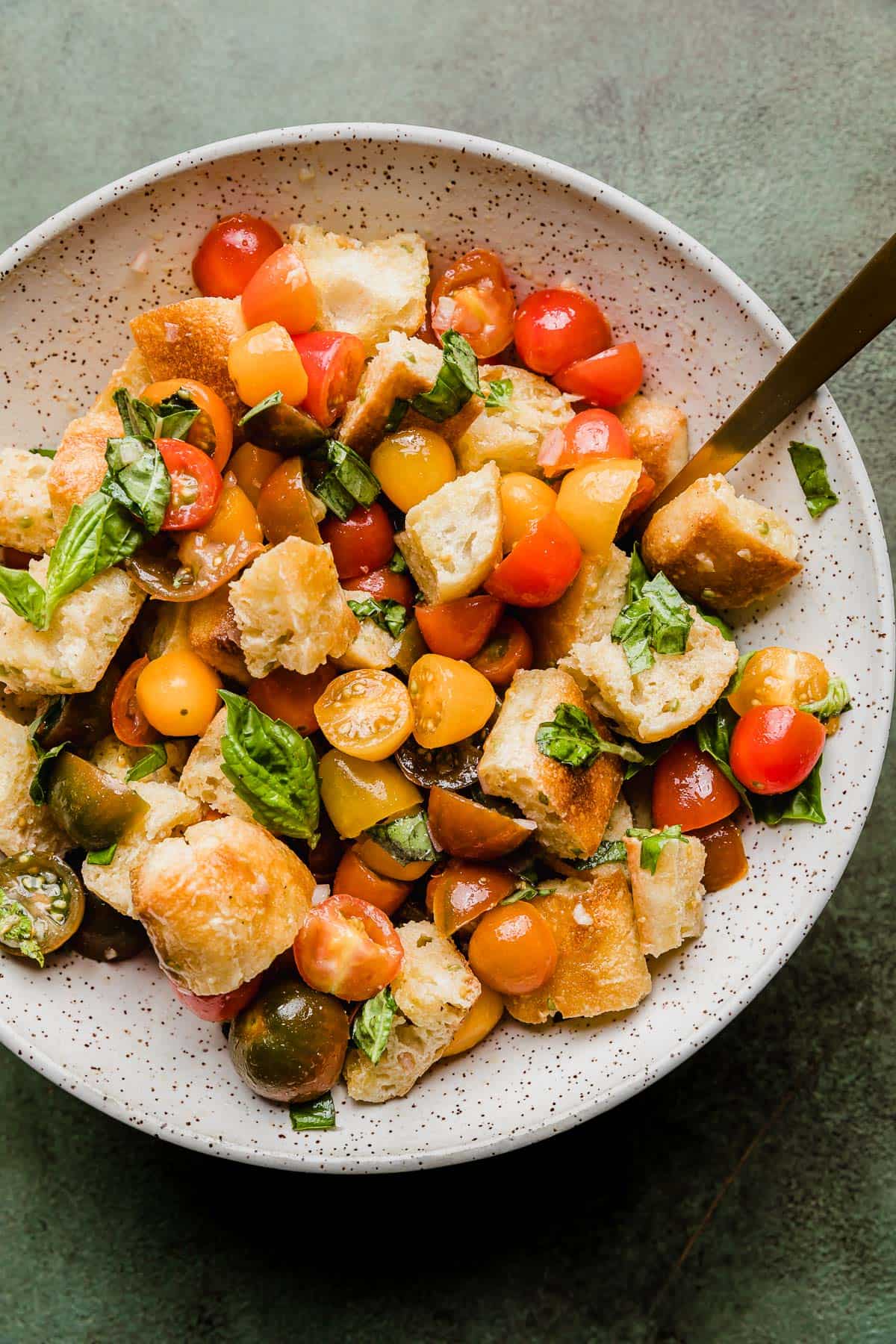 Cubed bread, chopped tomatoes, fresh basil with a Panzanella Toscana dressing drizzled overtop.